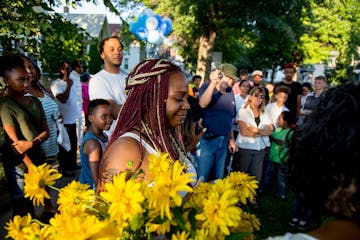 Kenyatta Foster approaches the crowd to speak at her father�s vigil on Friday night.