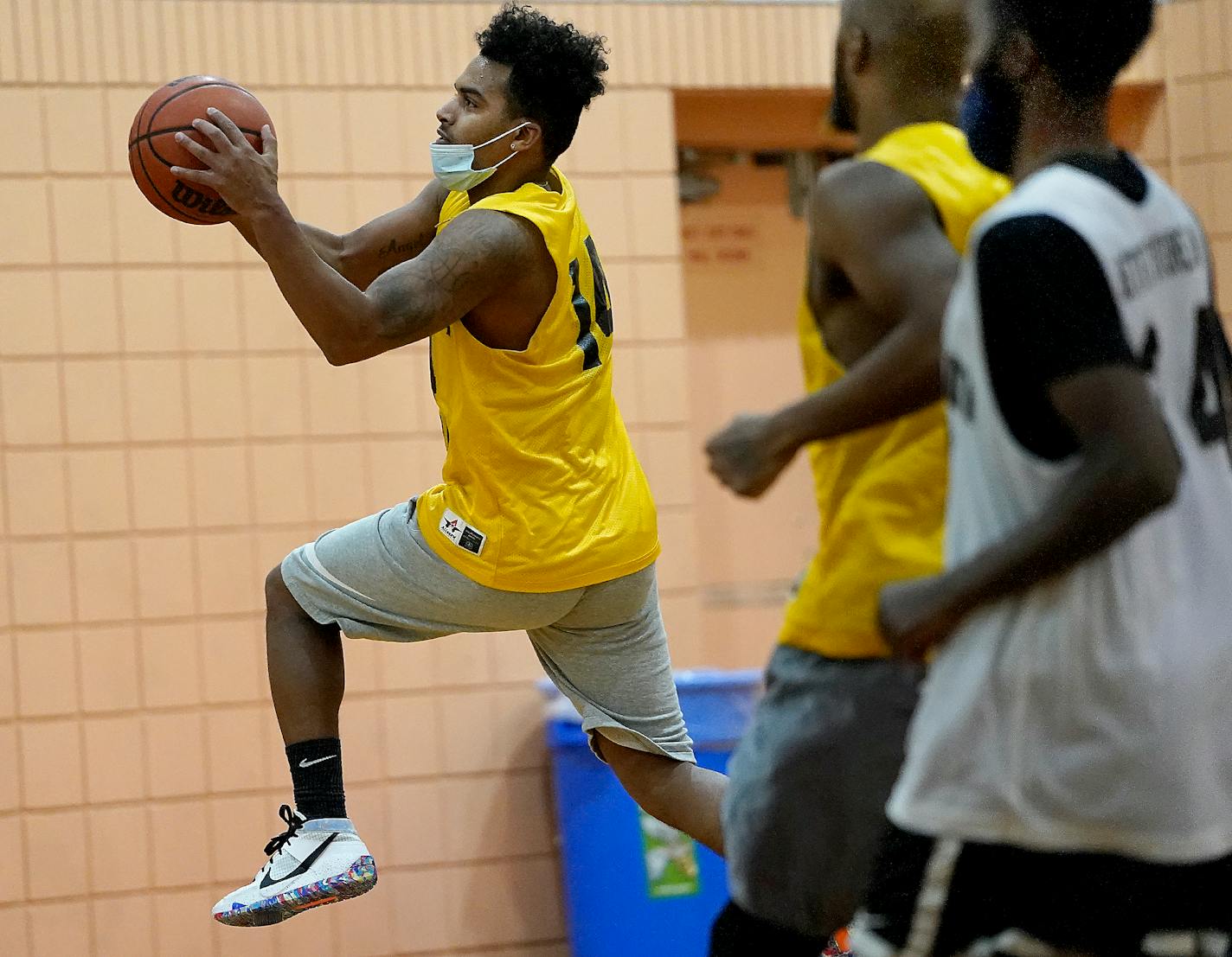 Bryce Williams, 26, of Staples, breaks to the basket during his adult basketball league game at Fairview Recreation Center Sunday in Minneapolis. Williams pleaded guilty in 2020 to federal arson in connection with the burning of the Minneapolis Police Department's Third Precinct in May. ]