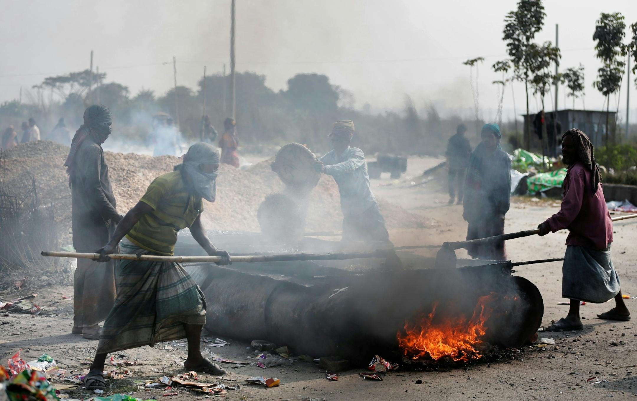 Bangladeshi laborers work at a construction site in Dhaka, Bangladesh, Friday, Dec. 30, 2016. On an average, each worker earns less than US$6 a day. (AP Photo) ORG XMIT: AMA104