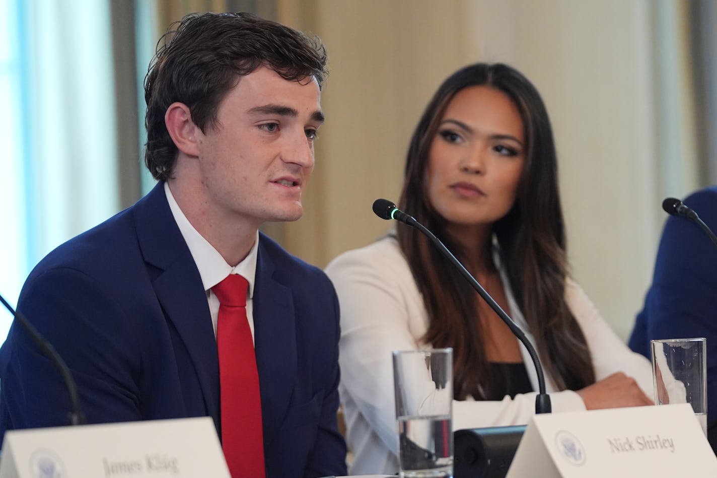 Nick Shirley speaks during a roundtable meeting with President Donald Trump on antifa in the State Dining Room at the White House, Wednesday, Oct. 8, 2025, in Washington, as Savanah Hernandez listens. (AP Photo/Evan Vucci)