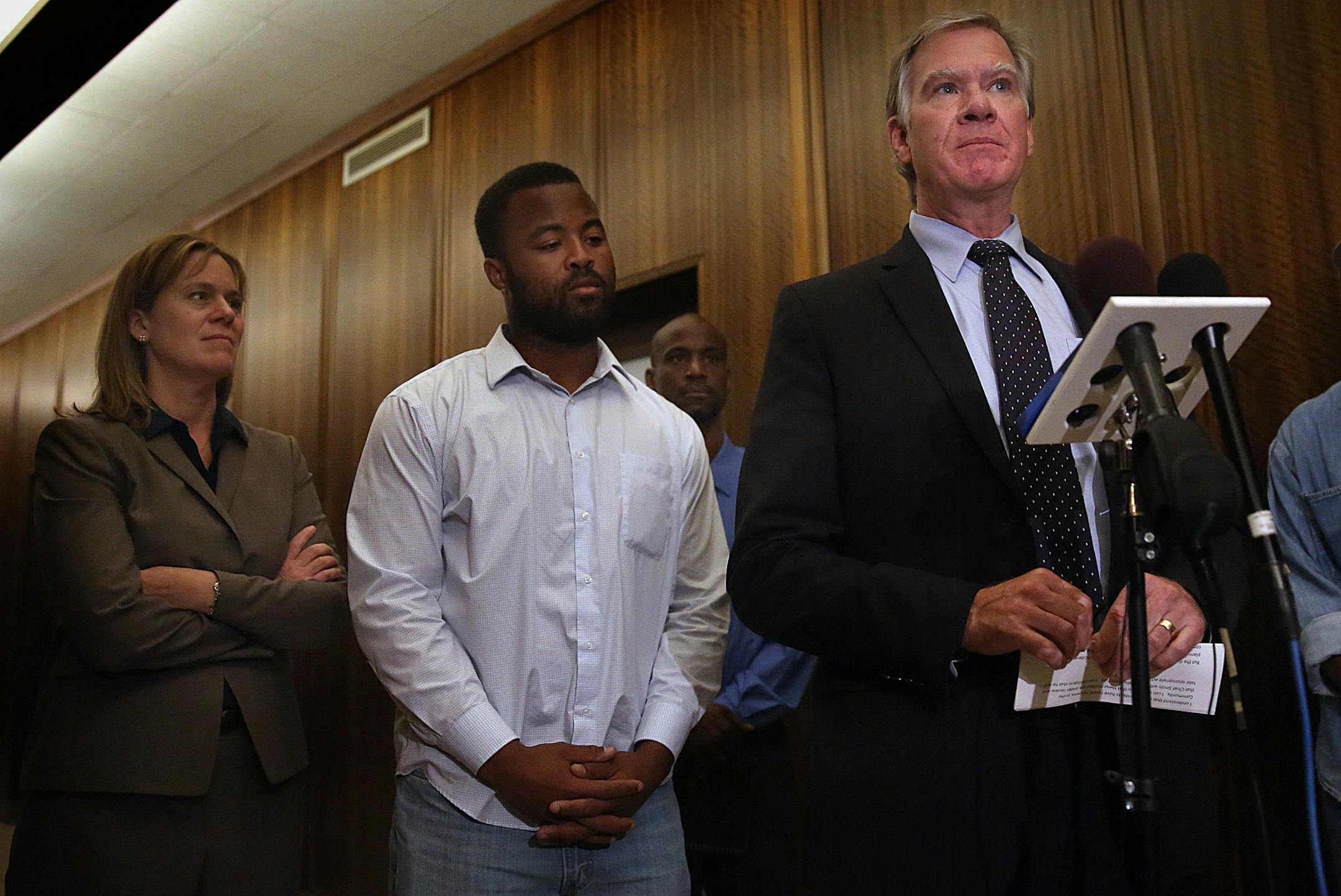 Rashad Turner, the leader of the St. Paul Black Lives Matter group (second from left), St. Paul Mayor Chris Coleman (at mic stand) and Saint Paul Deputy Mayor, Kristin Beckmann (left) appeared before members of the media following a meeting Thursday morning at the Mayor�s office.