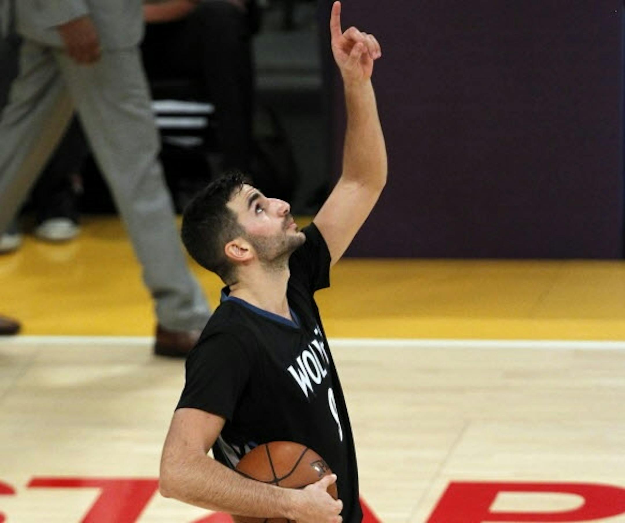 Wolves guard Ricky Rubio, who scored a career high 28 points, pointed skyward in honor of Flip Saunders after the final horn of Wednesday's season opening victory.