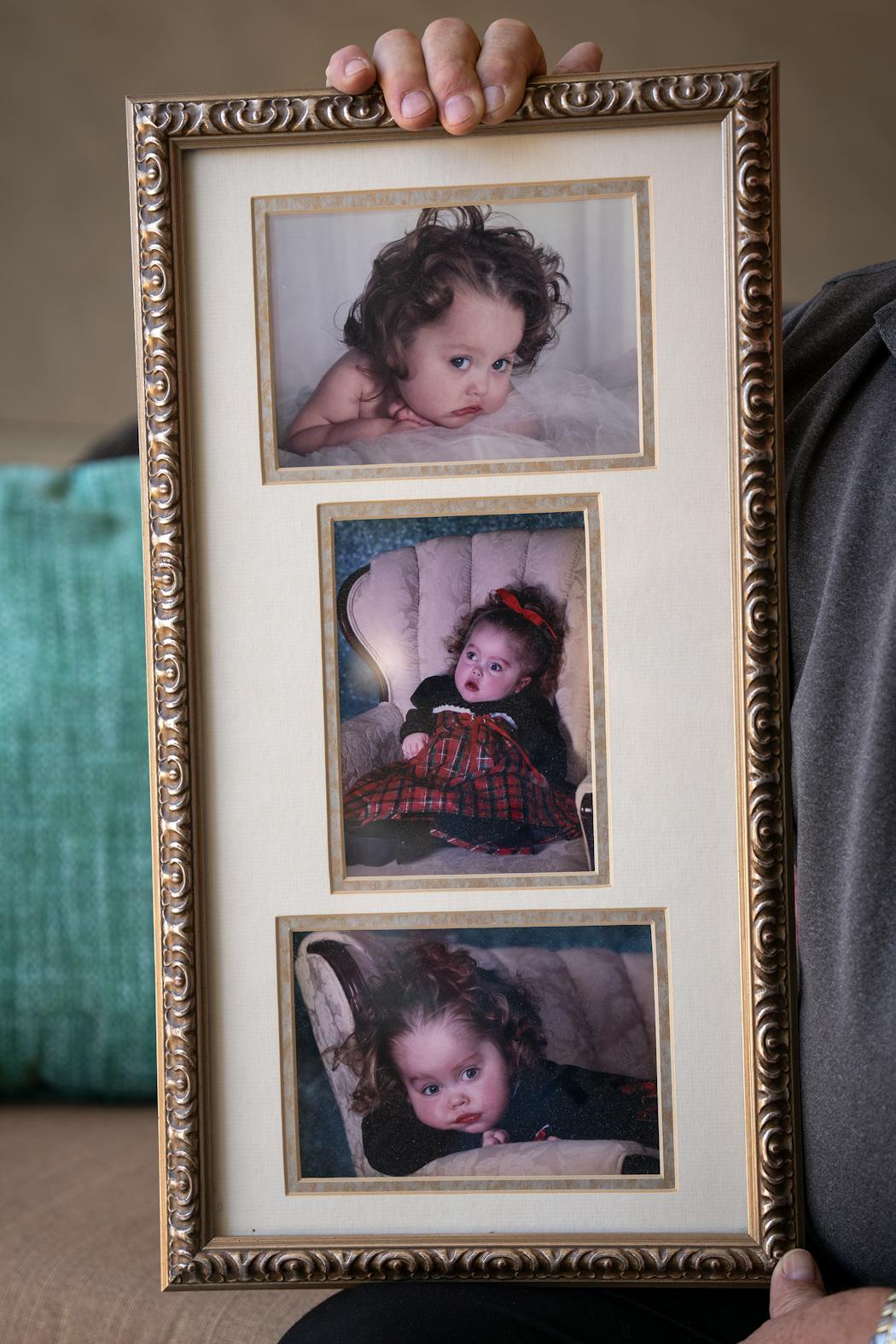 Paul Rosenau holds a frame with pictures of his granddaughter Mikayla.