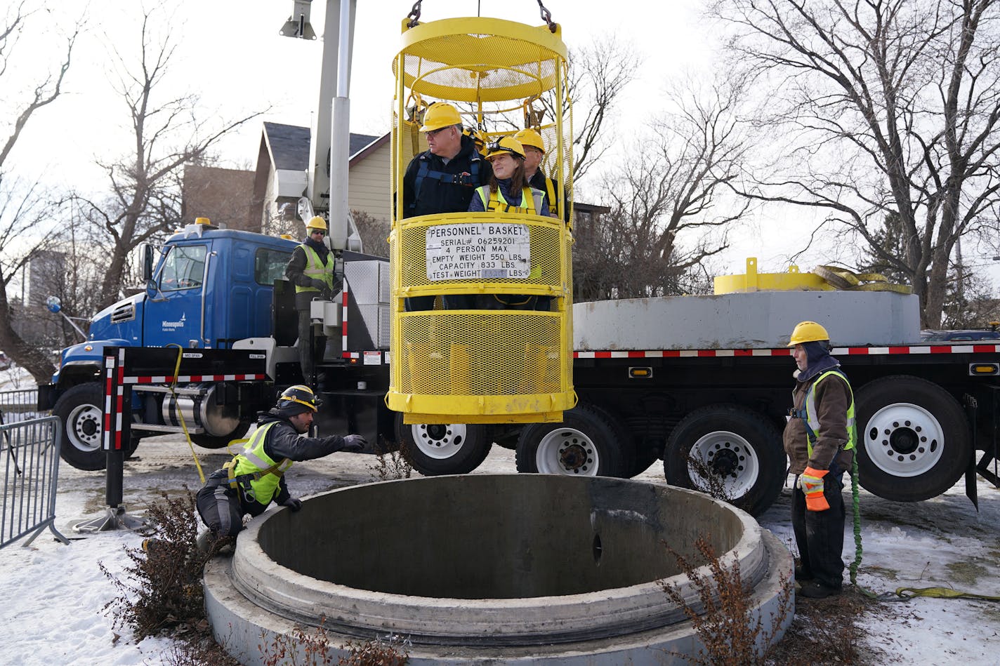 Gov. Tim Walz, commissioner of Minnesota Management and Budget Myron Frans, Minneapolis director of Public Works Robin Hutcheson, sewer engineer Joe Klejwa rode in a personnel basket back to the surface following an underground tour of the storm tunnel system in northeast Minneapolis Friday. ] ANTHONY SOUFFLE • anthony.souffle@startribune.com Gov. Tim Walz and Myron Frans, commissioner of Minnesota Management and Budget, toured a municipal storm tunnel after he unveiled the second piece of his b