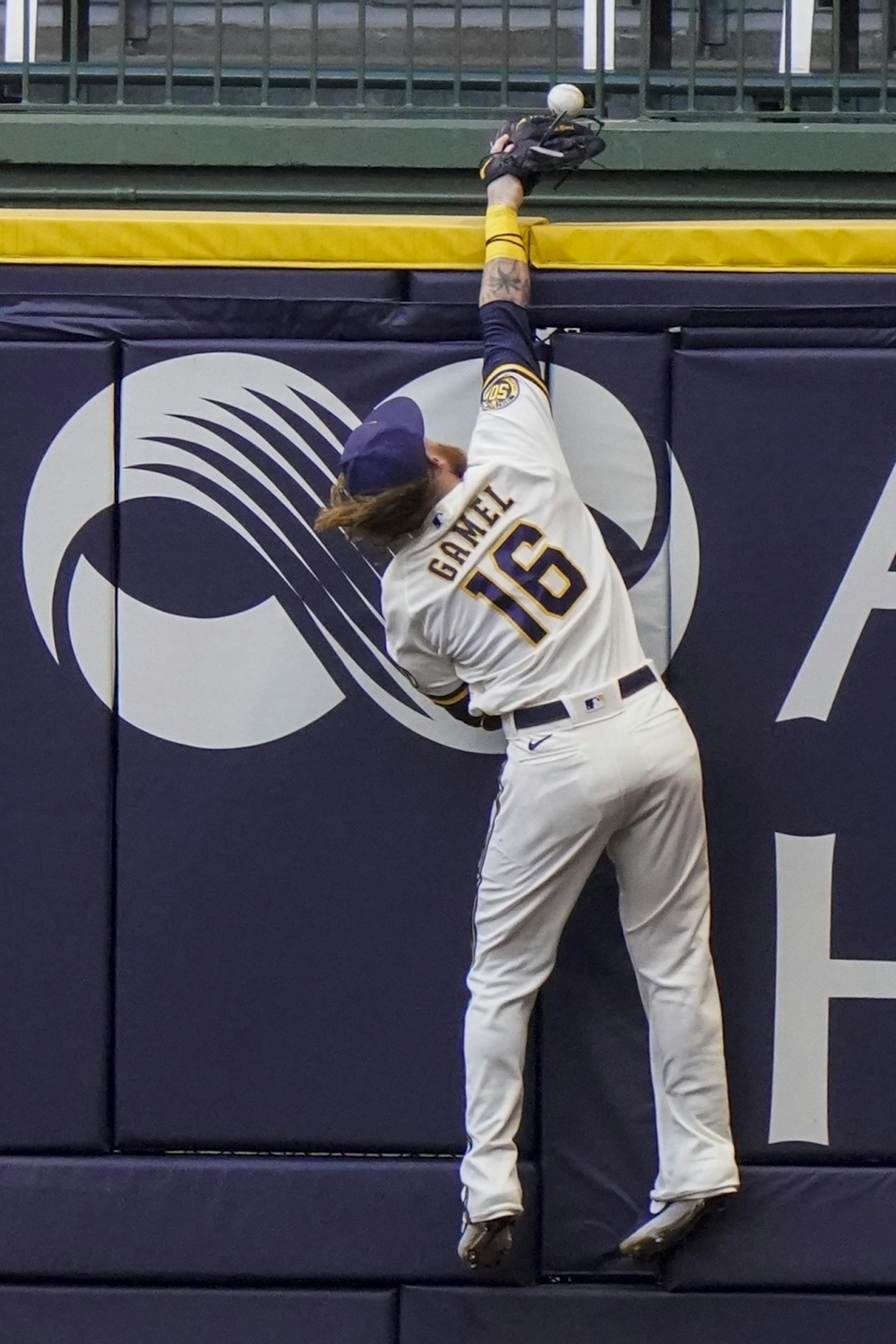 Milwaukee Brewers right fielder Ben Gamel can't catch a home run hit by Minnesota Twins' Eddie Rosario during the first inning of a baseball game Tuesday, Aug. 11, 2020, in Milwaukee.