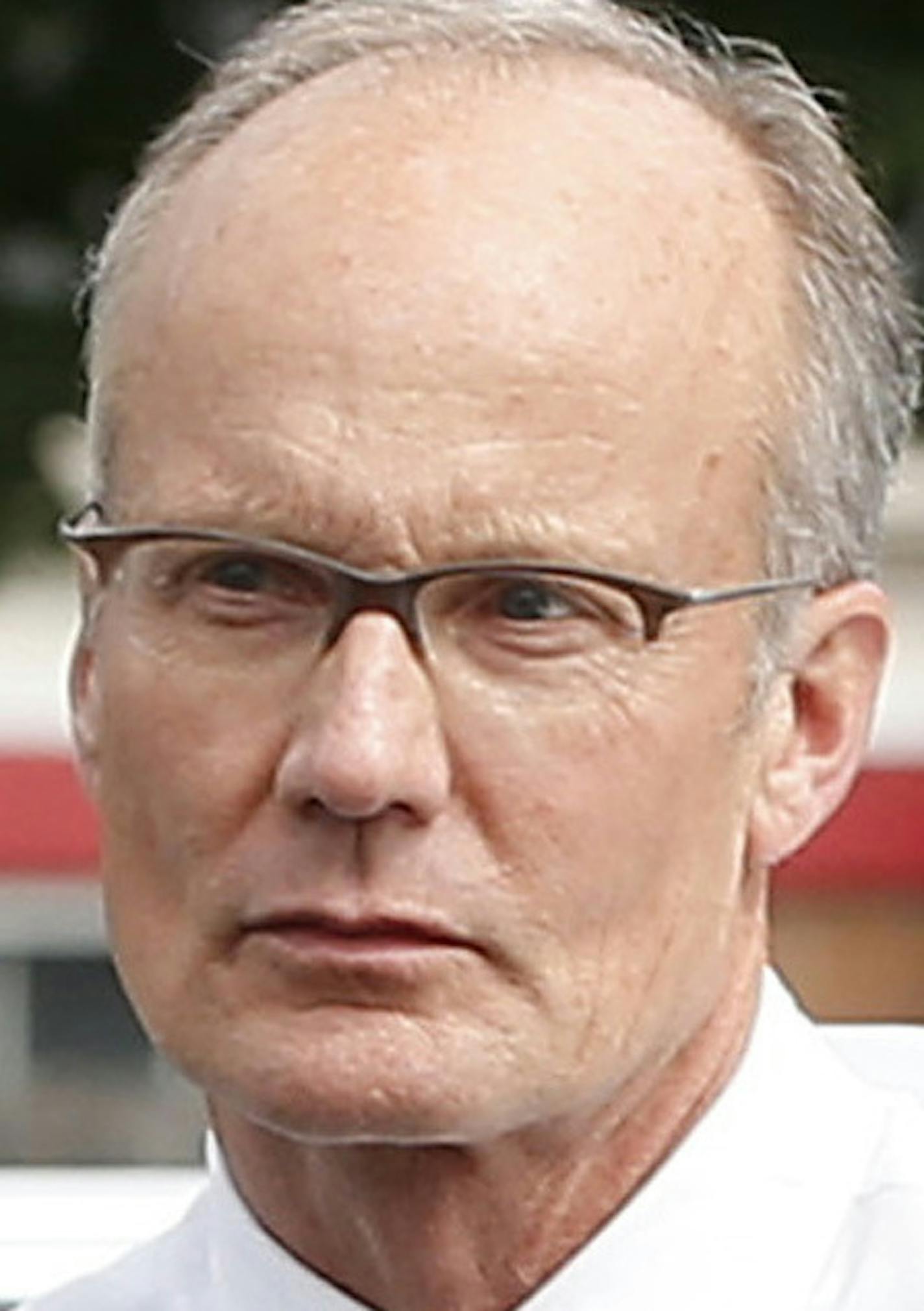 FILE- In this Tuesday, Sept. 8, 2015 file photo dentist Walter Palmer, arrives back at his office following a lunch break in Bloomington, Minn. A Zimbabwe Cabinet minister said Monday Oct. 12, 2015 that the country is no longer pressing for Palmer's extradition following the hunting and killing a well-known lion called Cecil. (AP Photo/Jim Mone-File)