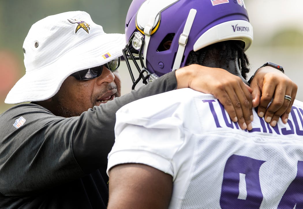 Co-defensive coordinator Andre Patterson with Dalvin Tomlinson during training camp. 