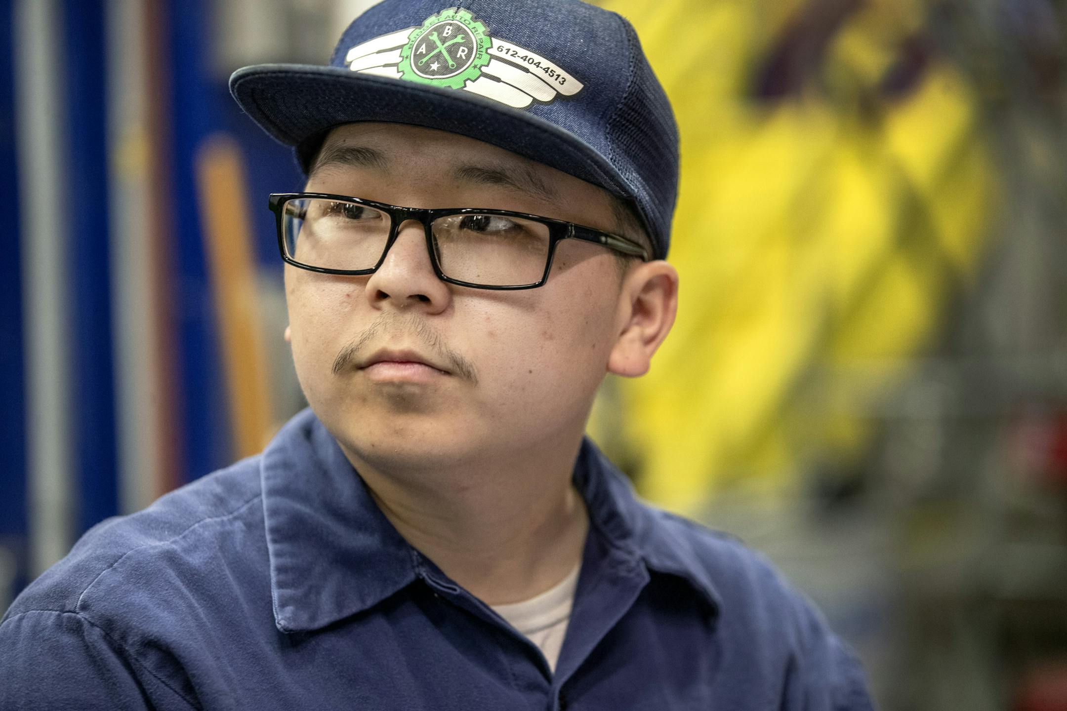 Chee Vang worked on a Metro Transit light-rail train at the St. Paul facility. Vang recently graduated from a two-year program at Hennepin Tech and now is working as an LRT technician. ] CARLOS GONZALEZ • cgonzalez@startribune.com – St. Paul, MN – August 14, 2019, Metro Transit has deployed a unique program to develop light-rail train technicians and has hired the first six graduates to make it through the intensive training program. Chee Vang recently graduated from a two-y