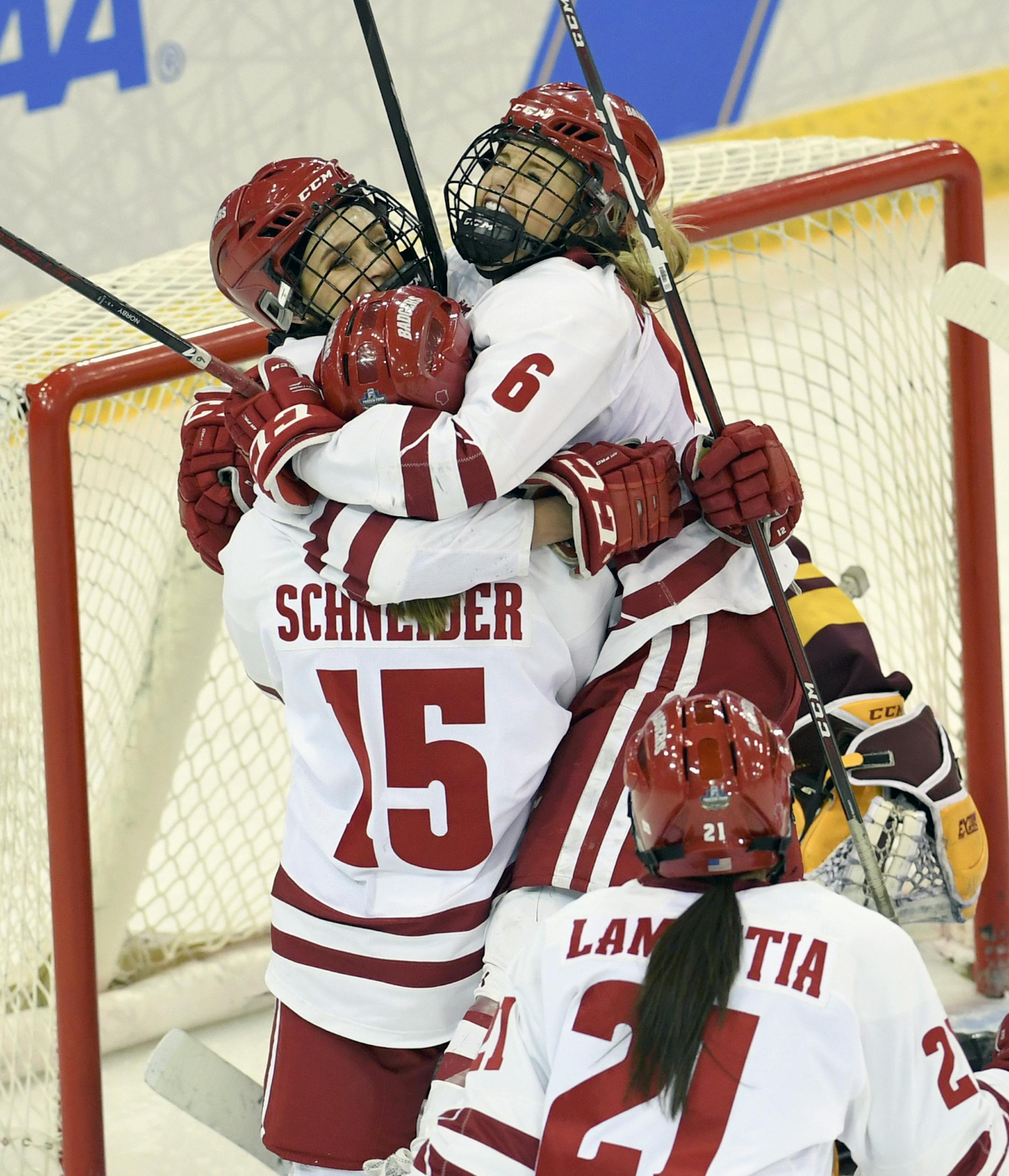 Wisconsin's Sophia Shaver (12), left, is hugged by teammates after scoring the first goal of the NCAA Division I women's Frozen Four hockey championship game during the first period against Minnesota, Sunday, March 24, 2019, in Hamden, Conn. (AP Photo/Stephen Dunn)