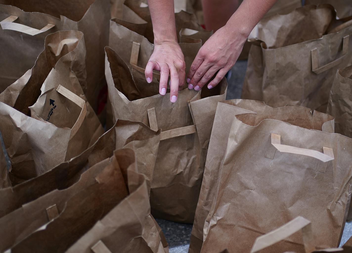 Volunteers searched bags for personal hygiene supplies people were requesting, also the most needed donation items, as they distributed bags of food Wednesday afternoon at Holy Trinity Lutheran Church. ] ANTHONY SOUFFLE • anthony.souffle@startribune.com Volunteers distributed food to those in need Wednesday, June 17, 2020 at Holy Trinity Lutheran Church in south Minneapolis. As the initial flood of pop up food shelves and donations have started to slow and organizations, community members and ci