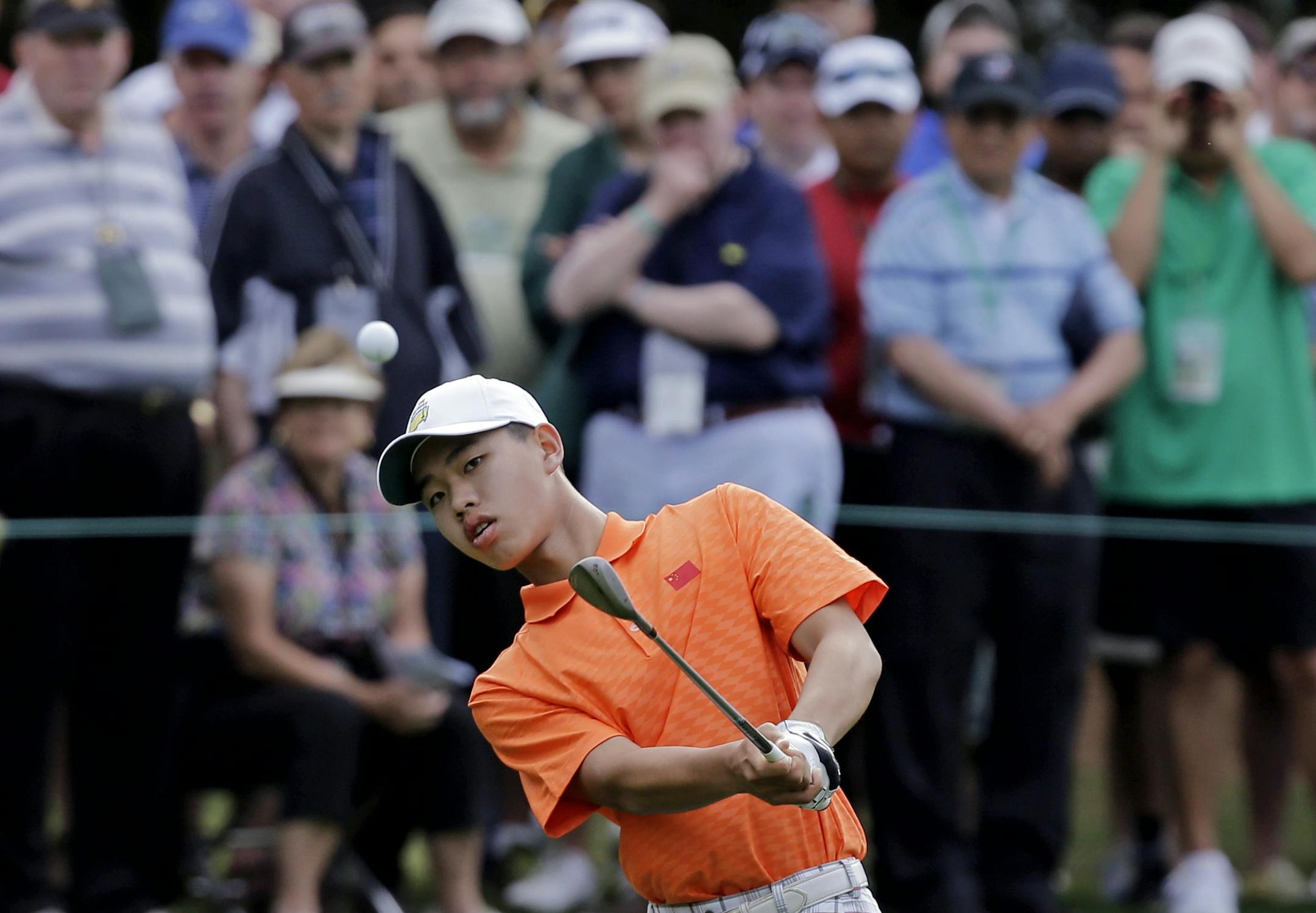 Amateur Guan Tianlang, of China, chips to the first green during the second round of the Masters golf tournament Friday, April 12, 2013, in Augusta, Ga. (AP Photo/David J. Phillip)
