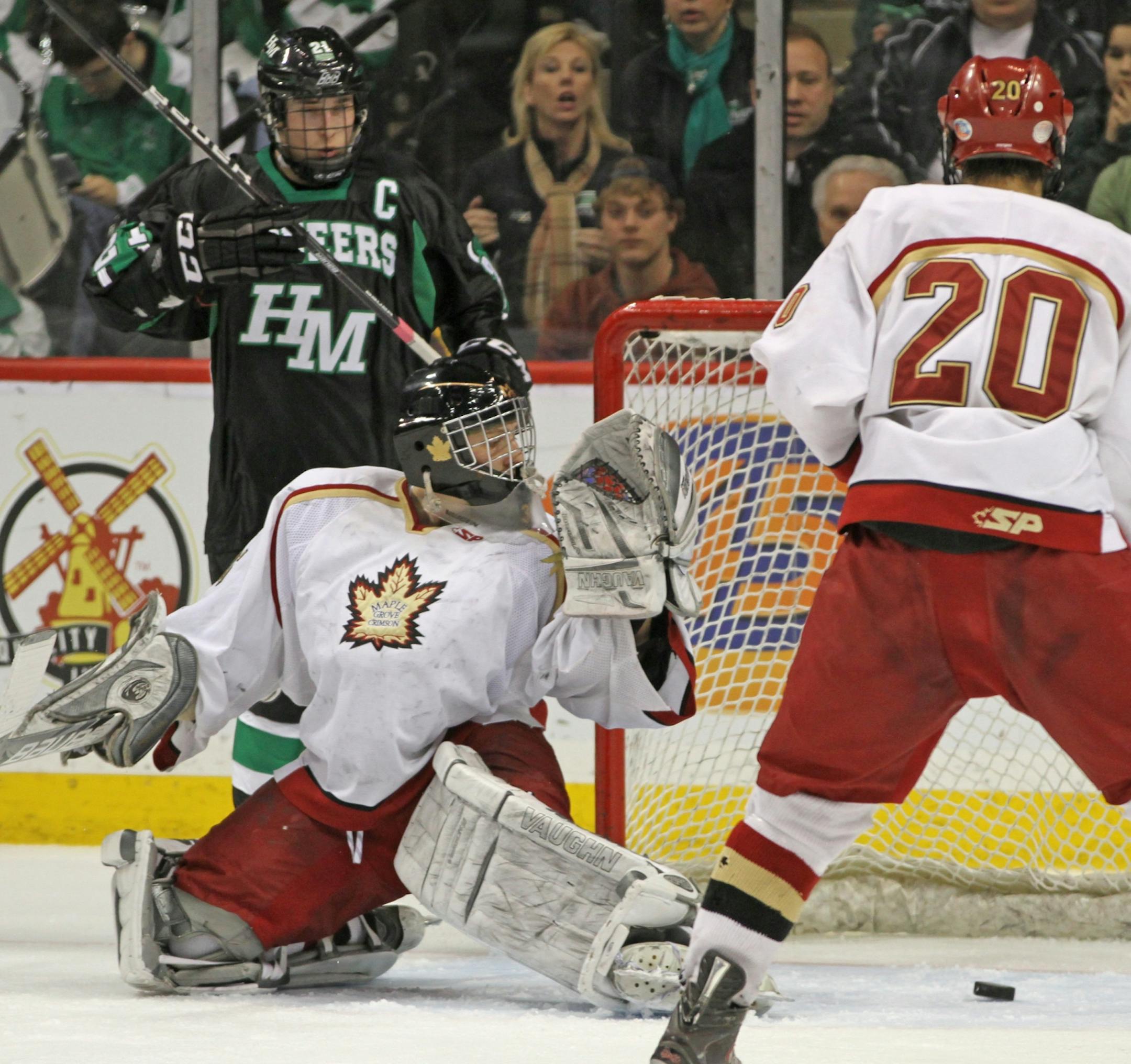 Boys State Hockey Tournament, Class AA quarterfinals, Hill Murray vs. Maple Grove, 3/8/12. (left to right) Maple Grove Goalie Kyle Koop looked back as Hill Murray's Charlie Sampair's shot went in for a 2nd period goal.