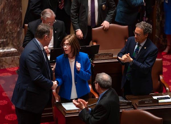 Senate Majority Leader Kari Dziedzic shook hands with fellow DFLer Nick Frentz moments after the Senate adjourned on May 22. 