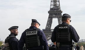FILE - Police officers patrol the Trocadero plaza near the Eiffel Tower in Paris, Tuesday, Oct. 17, 2023. The French Interior Minister said Friday tha