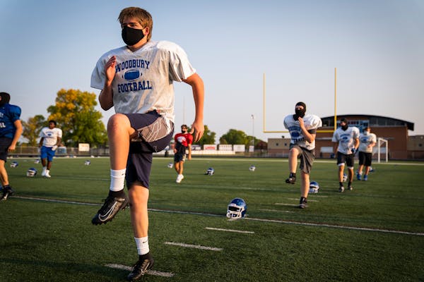 Offensive lineman Garrett Prestholdt warmed up during Woodbury High School football practice.