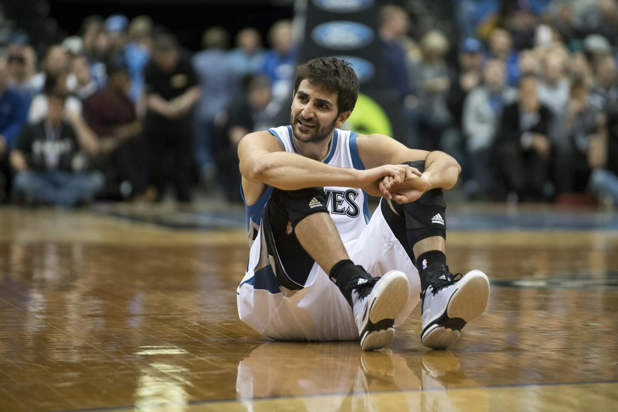 Minnesota Timberwolves guard Ricky Rubio (9) sits on the ground in frustration after being fouled on a shot but missing.