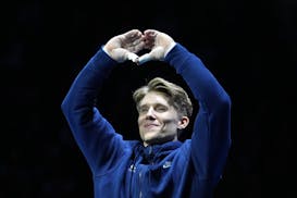 Former Gophers gymnast Shane Wiskus of Spring Park gestures to the Target Center crowd ahead of Day 2 of the U.S. Olympic trials in men's gymnastics o