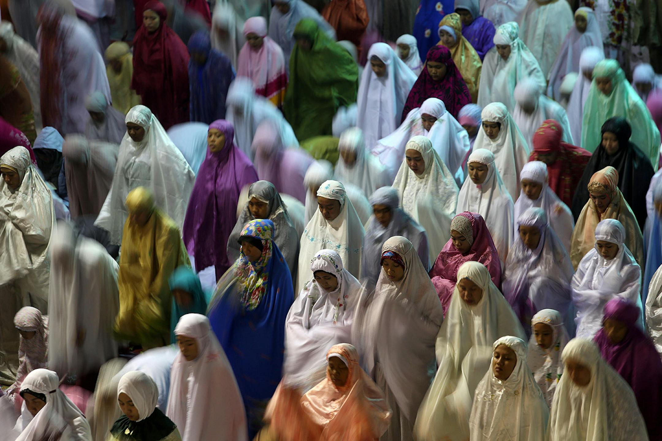 Muslim women perform an evening prayer called 'tarawih' marking the first eve of the holy fasting month of Ramadan, at Istiqlal Mosque in Jakarta, Indonesia, Saturday, June 28, 2014. During Ramadan, the holiest month in Islamic calendar, Muslims refrain from eating, drinking, smoking and sex from dawn to dusk. (AP Photo/Tatan Syuflana)