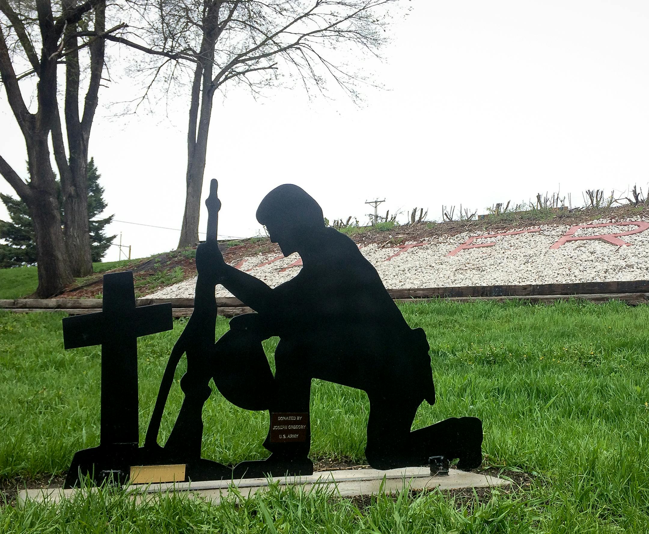 The Belle Plaine Veteran's Club had installed a monument depicting a kneeling soldier before a cross in the city's Veterans Memorial Park.