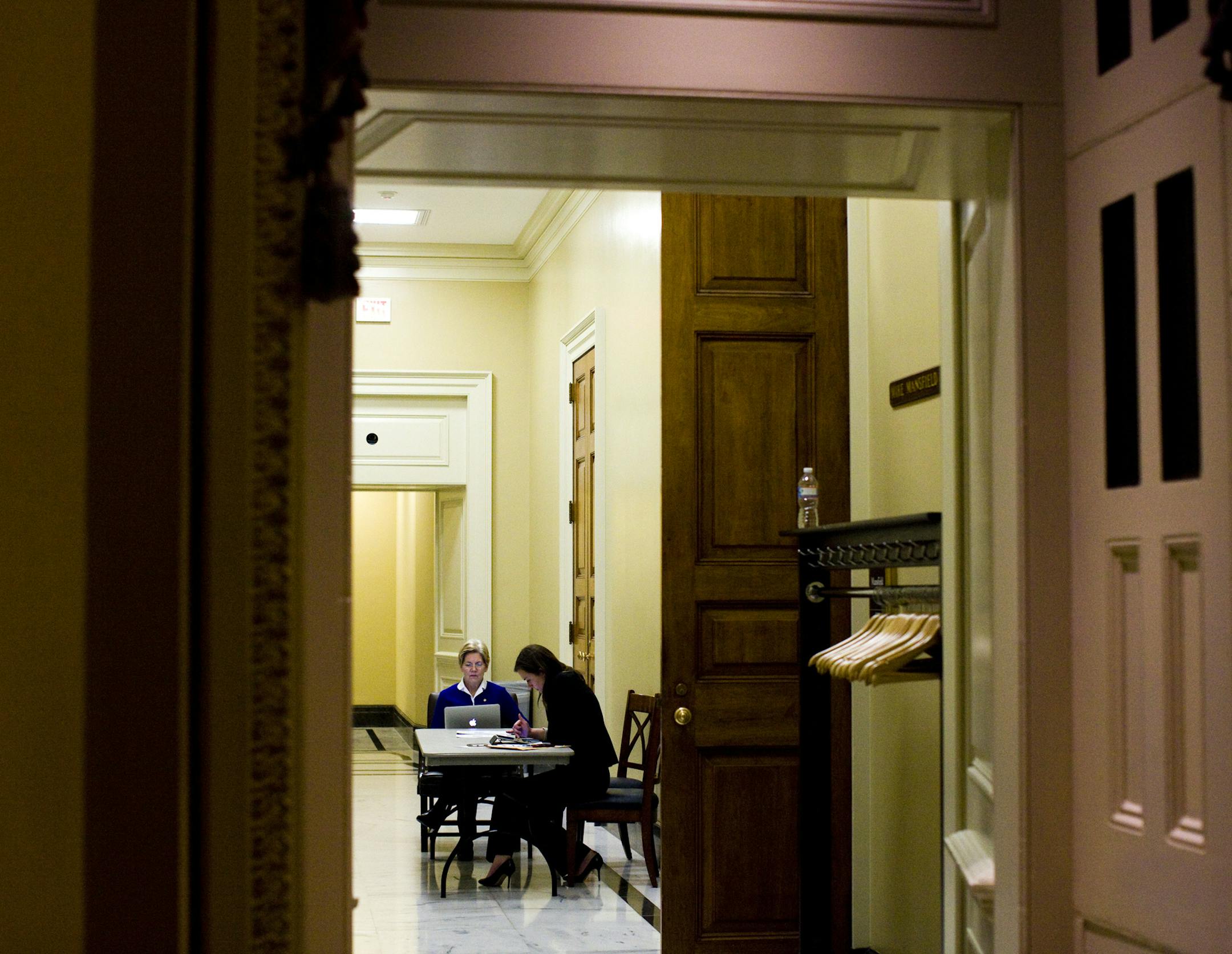 Sen. Elizabeth Warren (D-Mass.), left, before the final vote on the budget resolution, at the U.S. Capitol in Washington, March 22, 2013. After an all-night debate that ended just before 5 a.m., the Senate on Saturday adopted its first budget in four years, a $3.7 trillion plan for 2014 that would provide a fast track for passage of tax increases and trim spending. (Christopher Gregory/The New York Times)