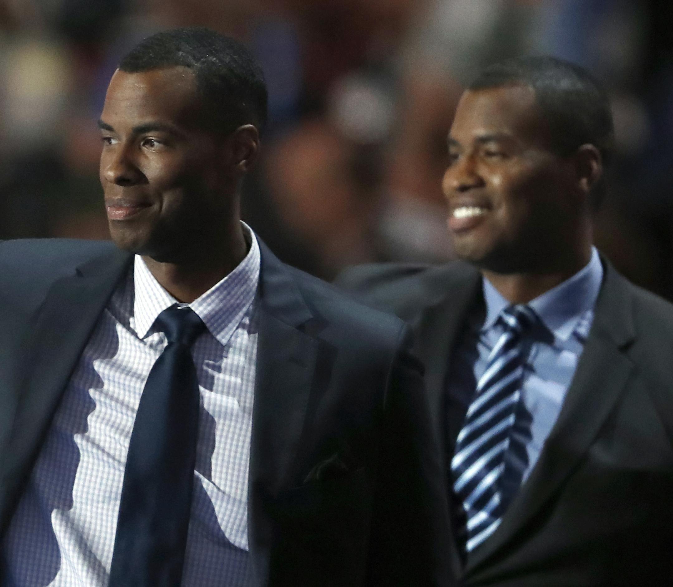 Jarron, left, and Jason Collins wave as they take the stage to speak during the first day of the Democratic National Convention in Philadelphia , Monday, July 25, 2016. (AP Photo/Paul Sancya)