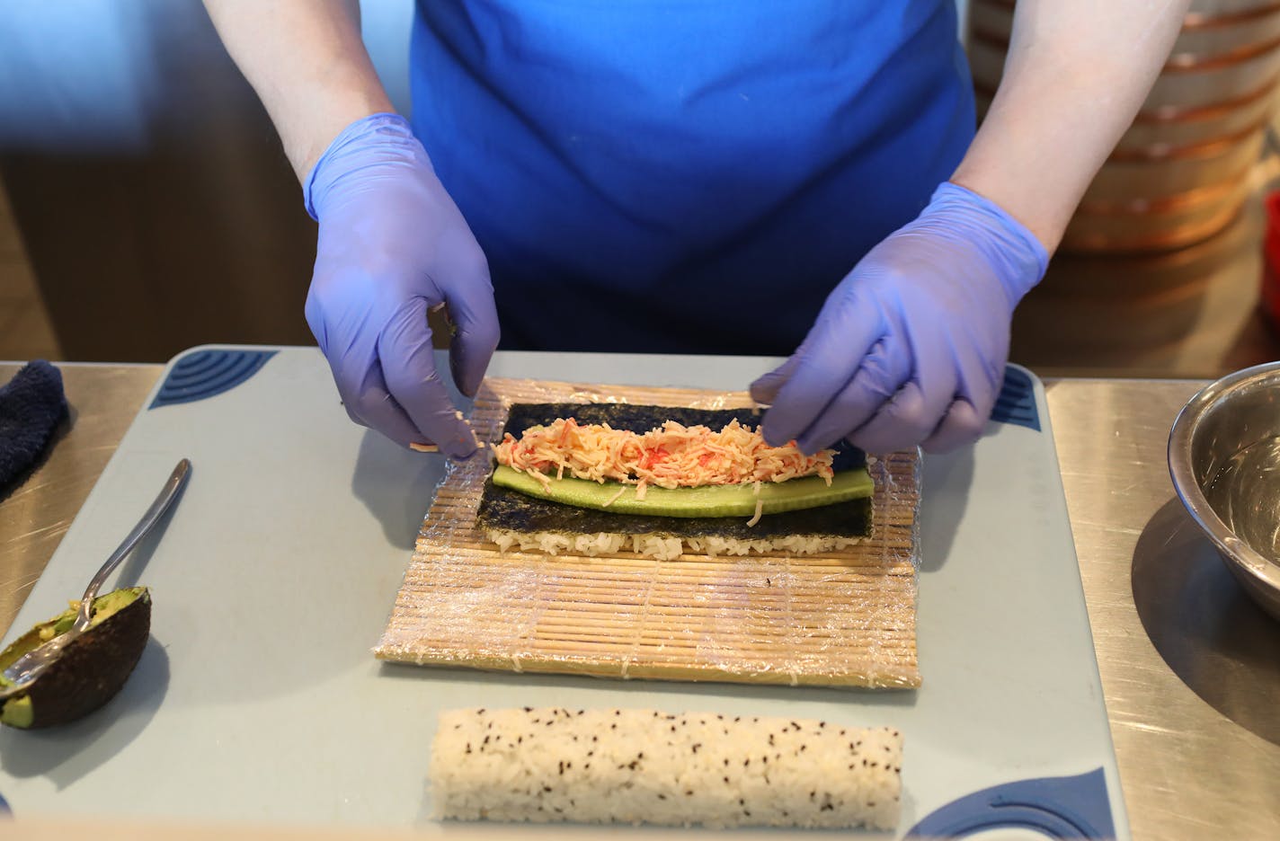 Xupeng Lin (cq) working at the Oceantail at Revolution hall. Here he prepares a sushi Calfornia roll. Revolution Hall, is the new food hall at Rosedale shopping center in Roseville. ] David Denney &#x2022; Star Tribune Minneapolis, 022019