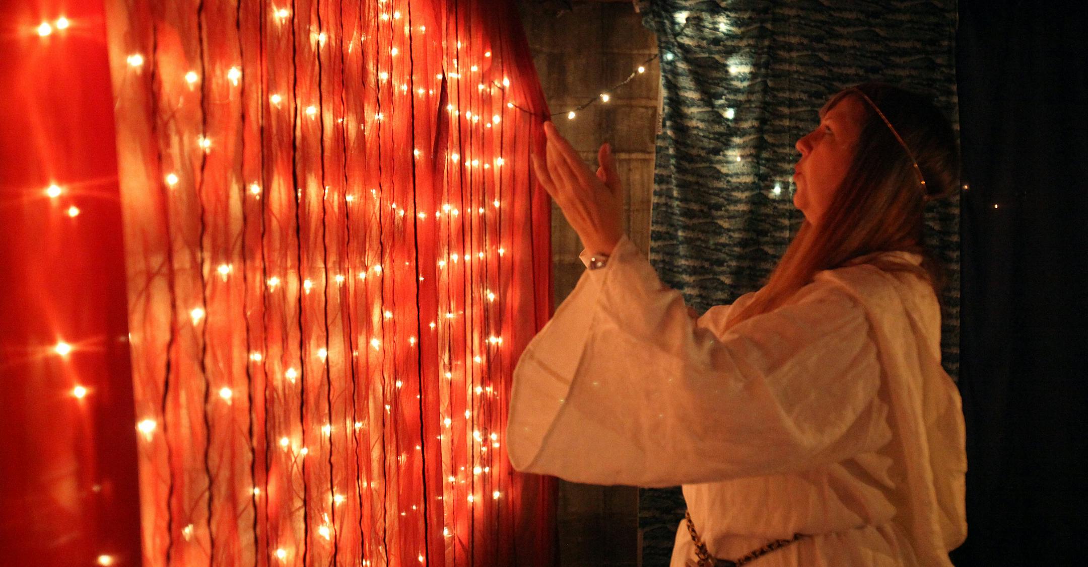 Louise Gastuch performs an invocation in the garb she wears at Wiccan rituals.