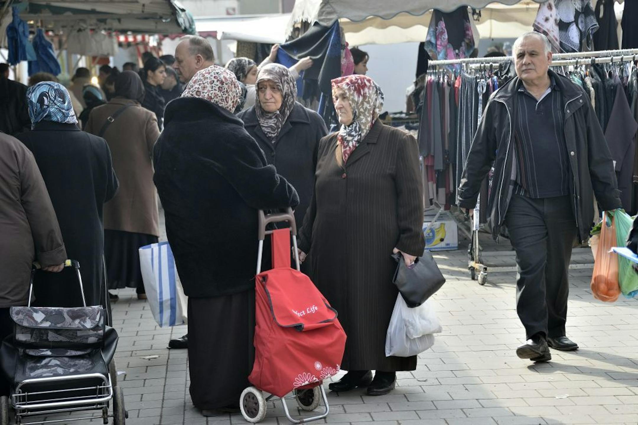 In this picture taken March 8, 2013, Turkish immigrants go shopping on a market in Duisburg-Bruckhausen, western Germany, .. Germany's experience with "guest workers" offers lessons for the United States as it debates immigration reform, including whether to provide a path to citizenship for unskilled foreign laborers.