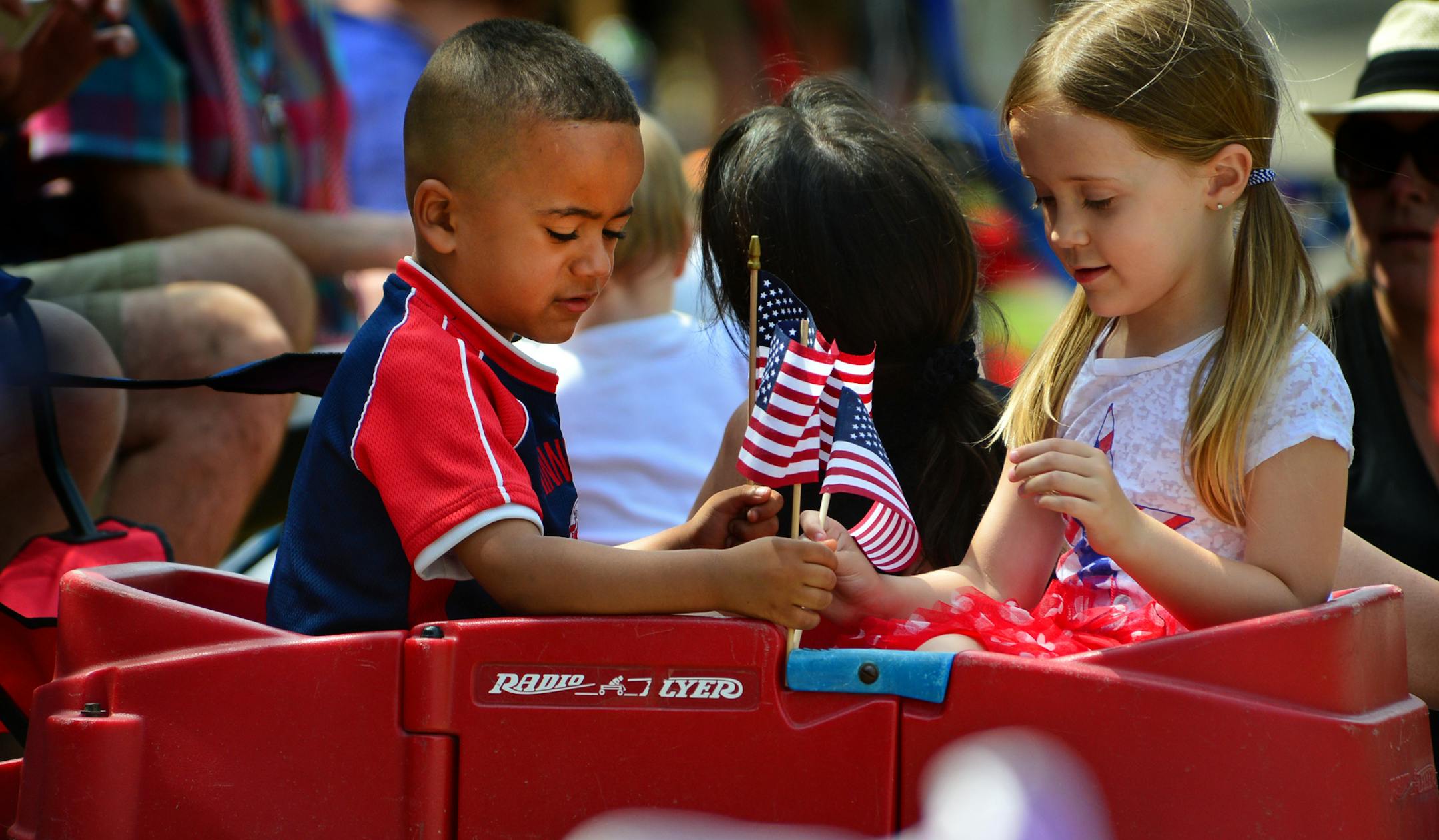 Amarii Kipka, 5 years old and Madison McCarthy 4 years old of Prescott Wisc. worked on decorating their wagon at the Afton 4th of July Parade. ]Thousands of people turned out on Afton's Main street for the 116th annual 4th of July Parade. Richard.Sennott@startribune.com Richard Sennott/Star Tribune Afton, Minn. Friday 7/4/2014) ** (cq)