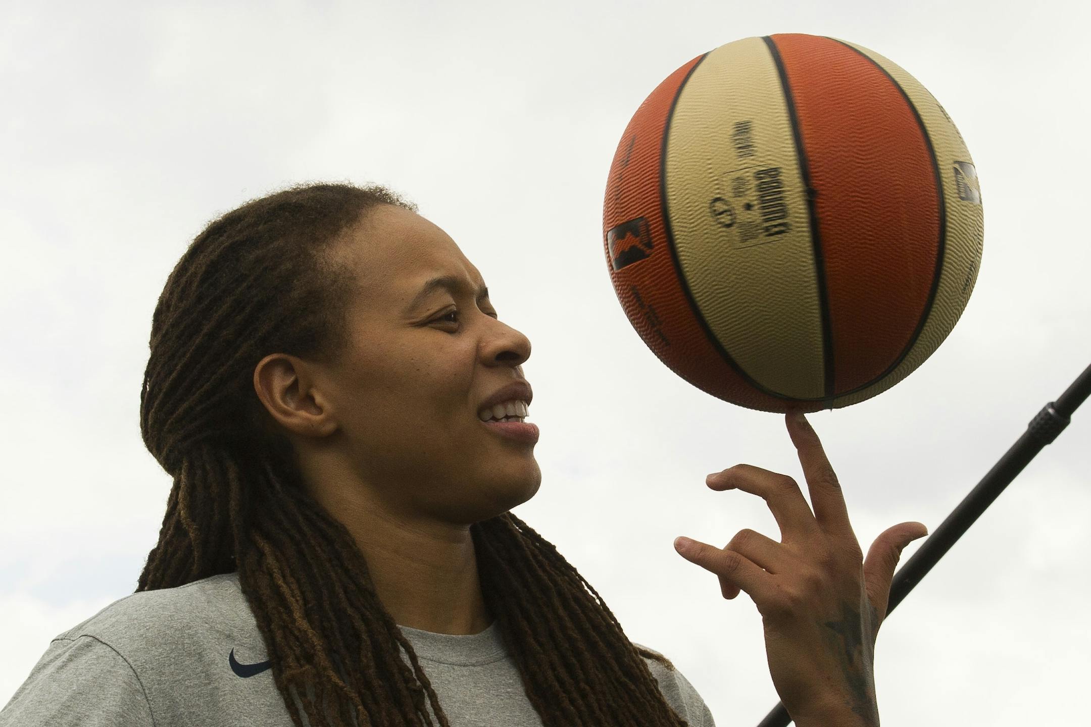 WNBA Champion Minnesota Lynx Guard Seimone Augustus spins a basketball on her finger while talking with students at Payne Elementary School in Washington, Wednesday, June 6, 2018. Payne Elementary has the highest homeless student population in the district.