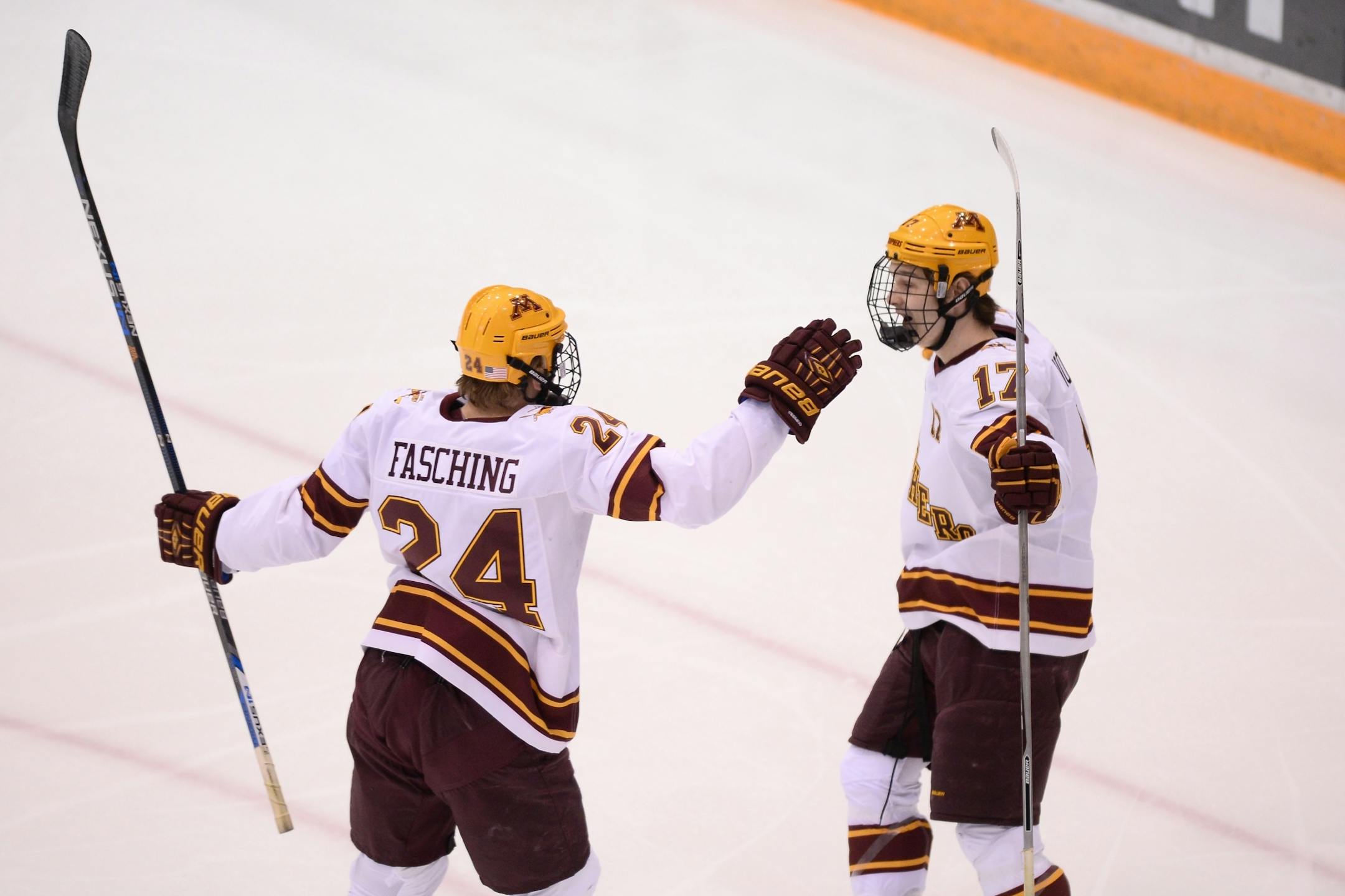 Minnesota Golden Gophers right wing Hudson Fasching (24) and center Tommy Novak (17) celebrated a goal by Fasching early in the first period against the Penn State Nittany Lions.