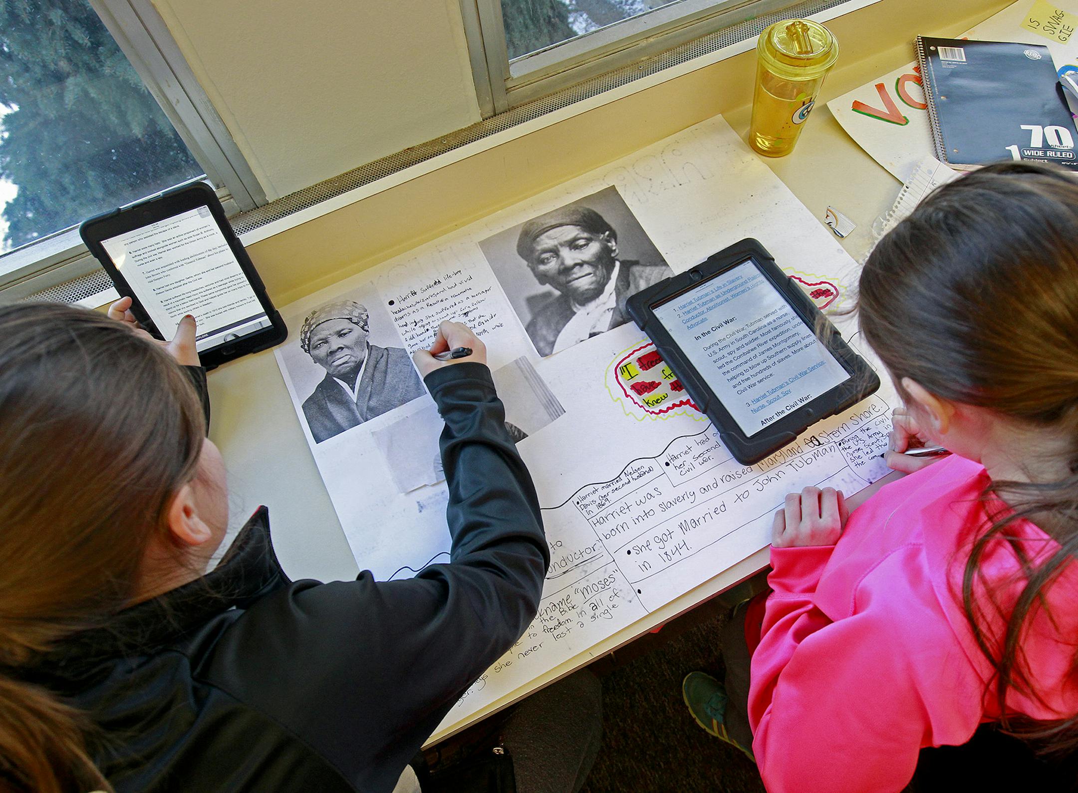 Elli Andriano-Allard, 10, left, and Megan Liebers, 10, worked on their "Hero" assignment for a class project at Gateway Academy, Wednesday, December 17, in Farmington, MN. ] (ELIZABETH FLORES/STAR TRIBUNE) ELIZABETH FLORES • eflores@startribune.com