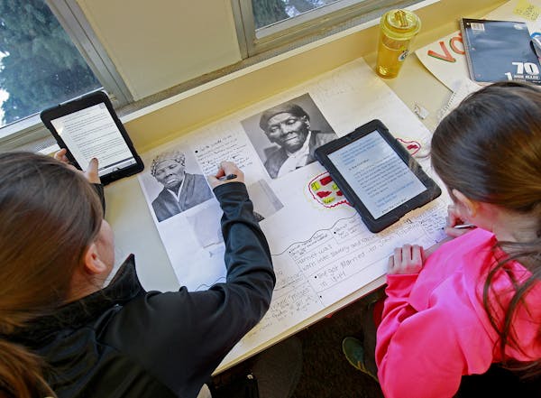 Elli Andriano-Allard, 10, left, and Megan Liebers, 10, worked on their "Hero" assignment for a class project at Gateway Academy, Wednesday, December 1