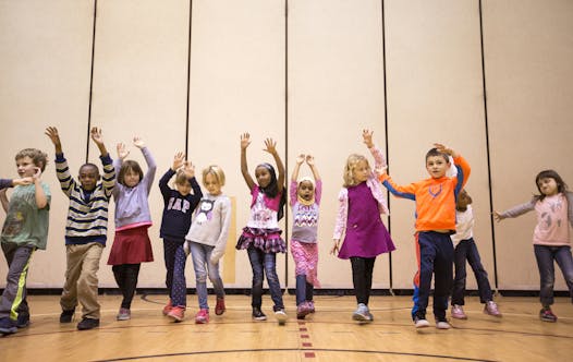 First-graders at Marcy Open School learned how to walk in unison across the gym floor before incorporating improvised moves.