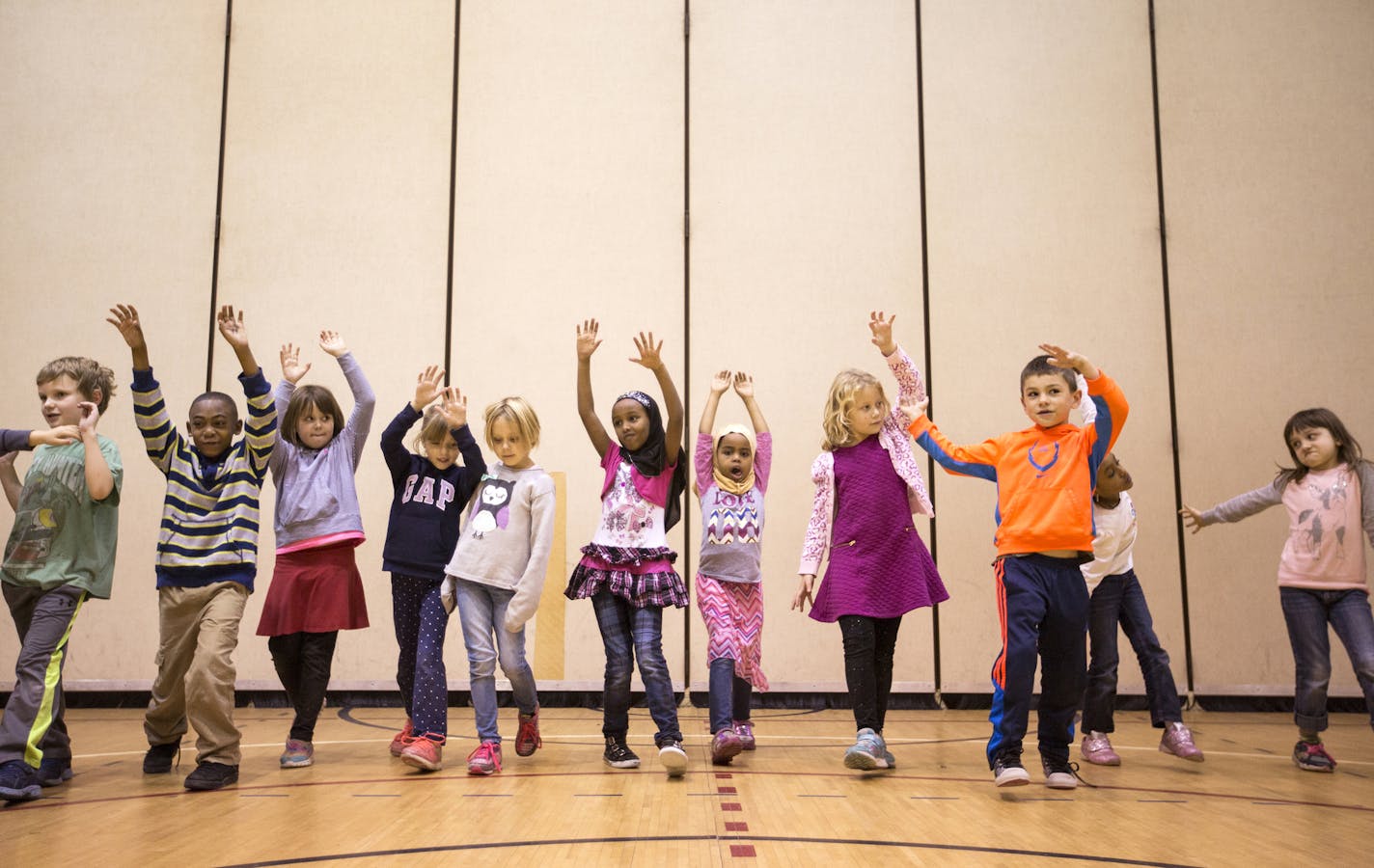 First-graders at Marcy Open School learned how to walk in unison across the gym floor before incorporating improvised moves.