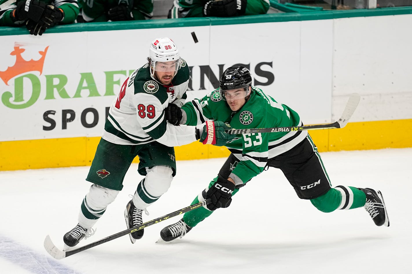 Wild center Frederick Gaudreau and Dallas center Wyatt Johnston chased after an airborne puck in the third period of Game 5.