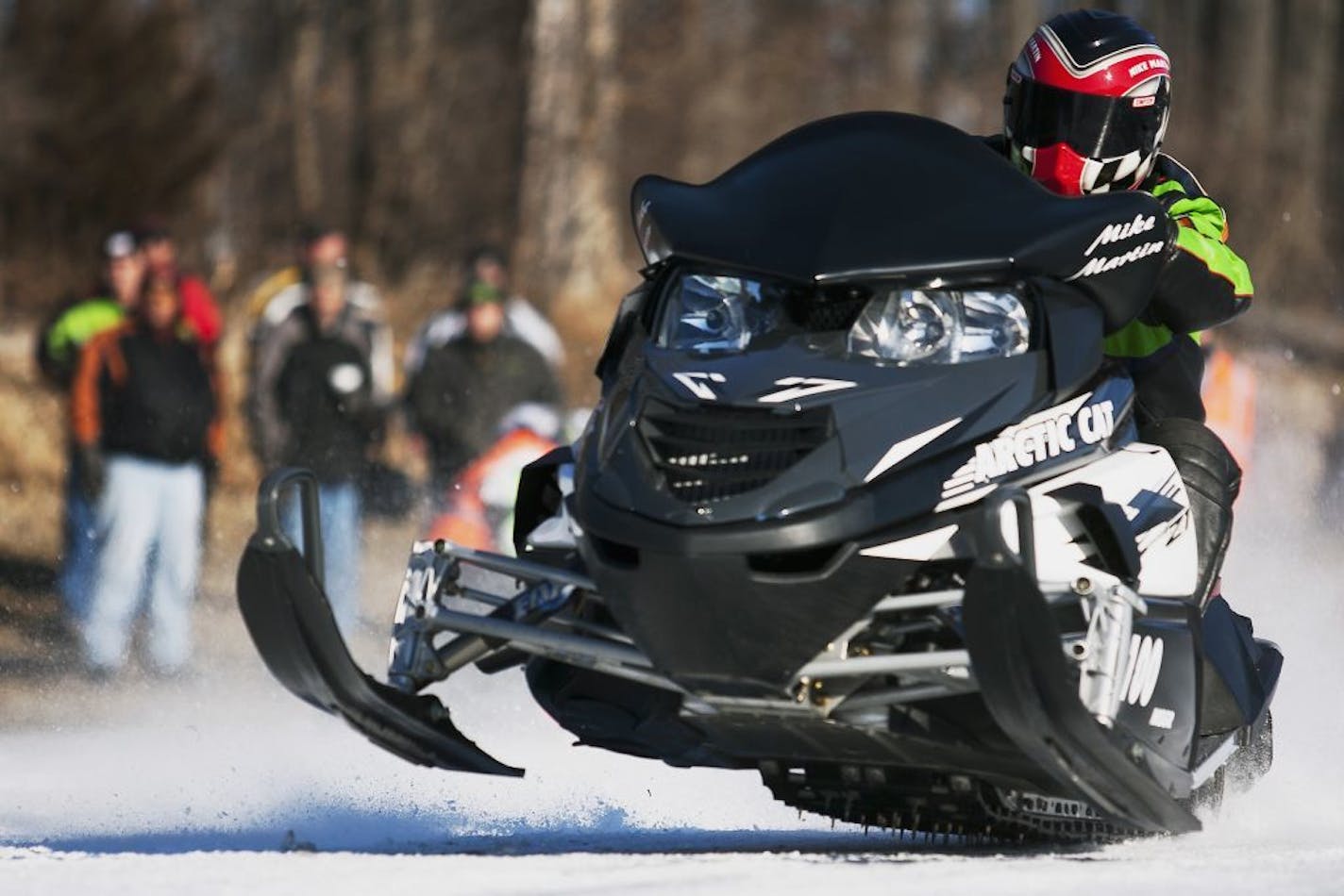 FILE - In this Jan. 6, 2013, file photo, Mike Martin, of Galesburg, Ill., drives his Arctic Cat snowmobile during the Annual Prairie Drifters Snowmobile Radar Run at Lake Storey in Galesburg. The defense contractor Textron is buying the snowmobile maker Arctic Cat in a deal valued at about $247 million. Textron said Wednesday, Jan. 25, 2017, that it will pay $18.50 per Arctic Cat share, a 41 percent premium to its Tuesday closing price.