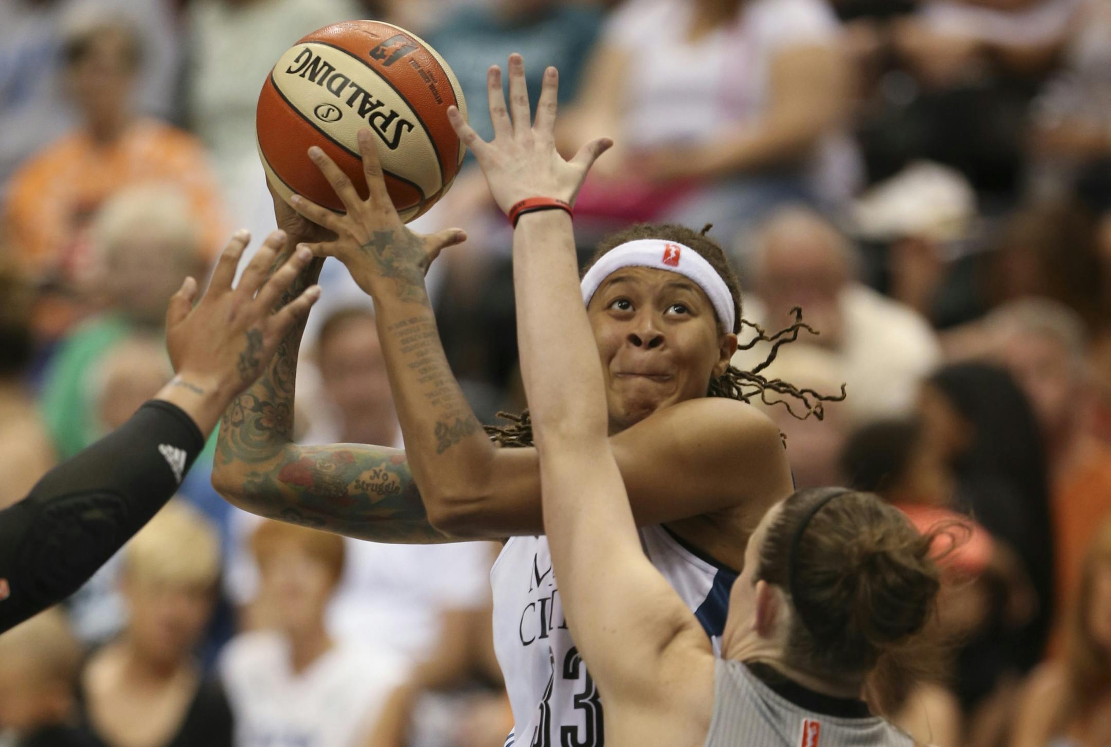 The Lynx' Seimone Augustus looked for a shot over the defense of the Stars' Samantha Logic in the third quarter Sunday night at Target Center.