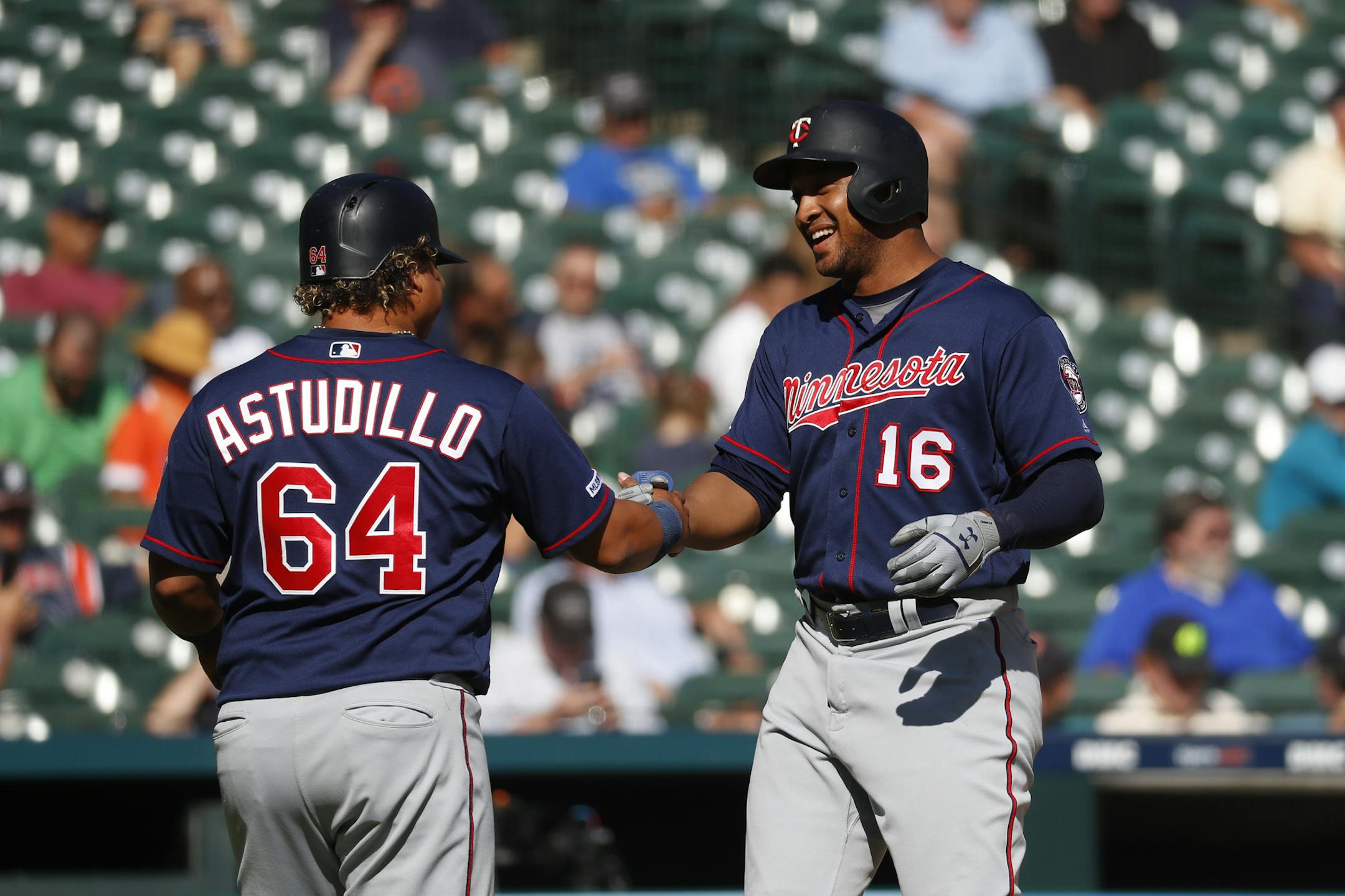 Minnesota Twins' Jonathan Schoop (16) celebrates his two-run home run with Willians Astudillo (64) during the seventh inning of a baseball game against the Detroit Tigers in Detroit, Thursday, Sept. 26, 2019. (AP Photo/Paul Sancya)