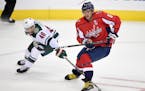 Minnesota Wild defenseman Jared Spurgeon (46) battles for the puck against Washington Capitals left wing Alex Ovechkin (8), of Russia, during the thir