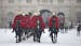 Troops of the Household Cavalry mounted division leave Horseguards parade after their ceremonial duty as it begins to snow in London, Friday, Jan. 18,
