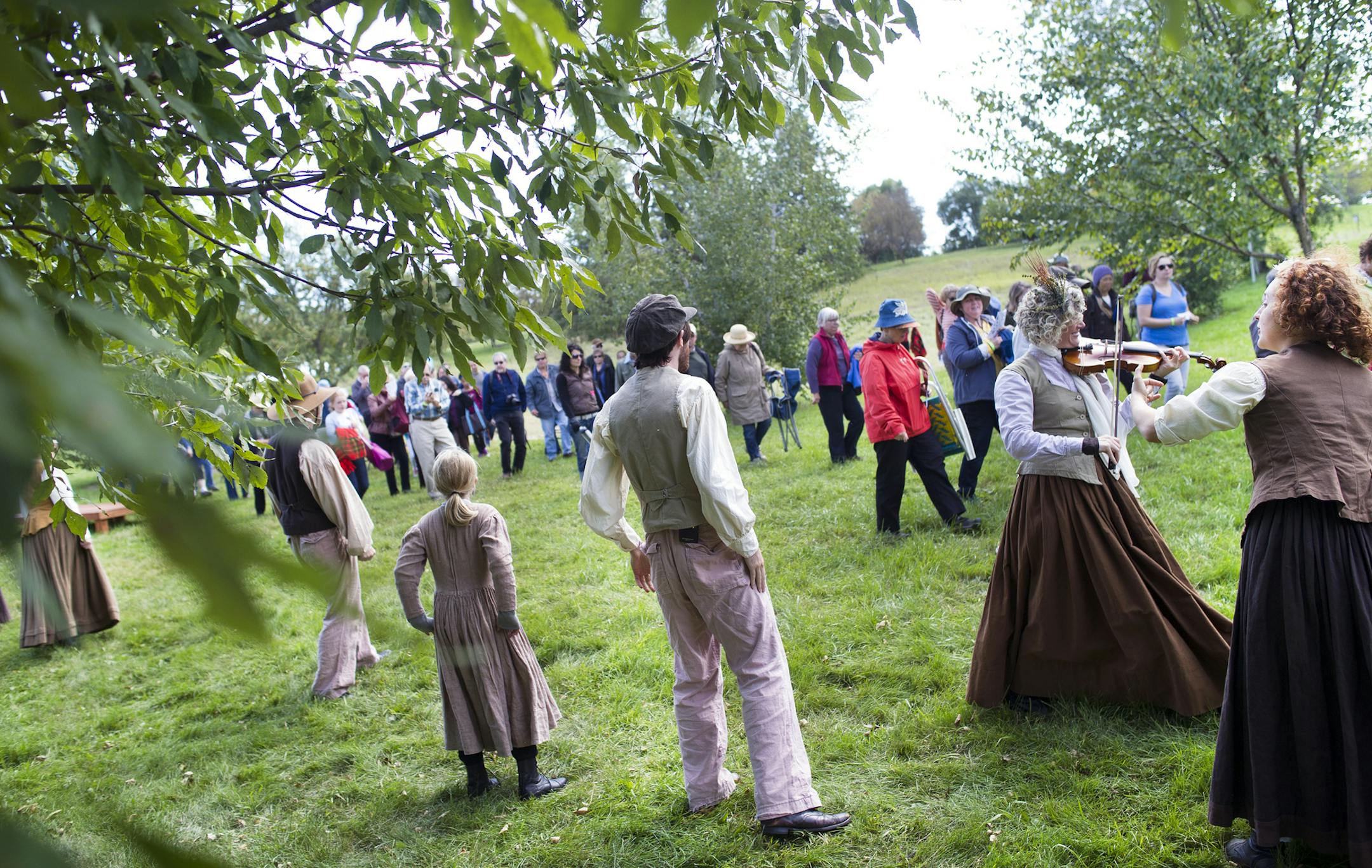 The cast and audience move together through the lush greenery of the Minnesota Landscape Arboretum, Saturday afternoon, during a performance of "Nature", a walking play which portrays Emerson and Thoreau's love for the natural world. ] (Matthew Hintz, 09