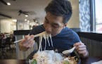 ] MARK VANCLEAVE &#x2022; mark.vancleave@startribune.com * Kai Chan, a local food and travel Instagrammer, attempts to down the the 10-lb. pho challen