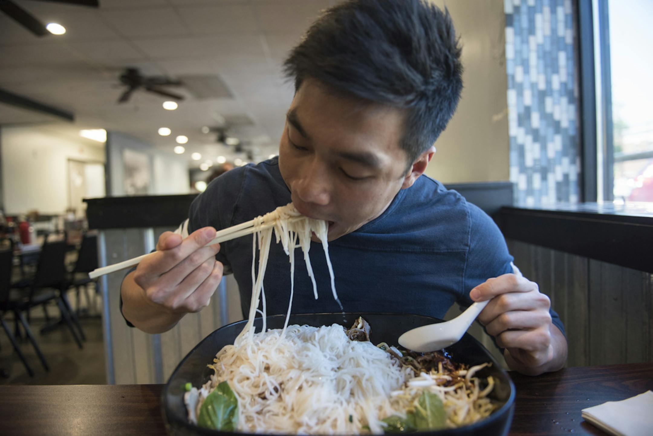 ] MARK VANCLEAVE • mark.vancleave@startribune.com * Kai Chan, a local food and travel Instagrammer, attempts to down the the 10-lb. pho challenge at iPho by Saigon, in St. Paul on May 31, 2017.