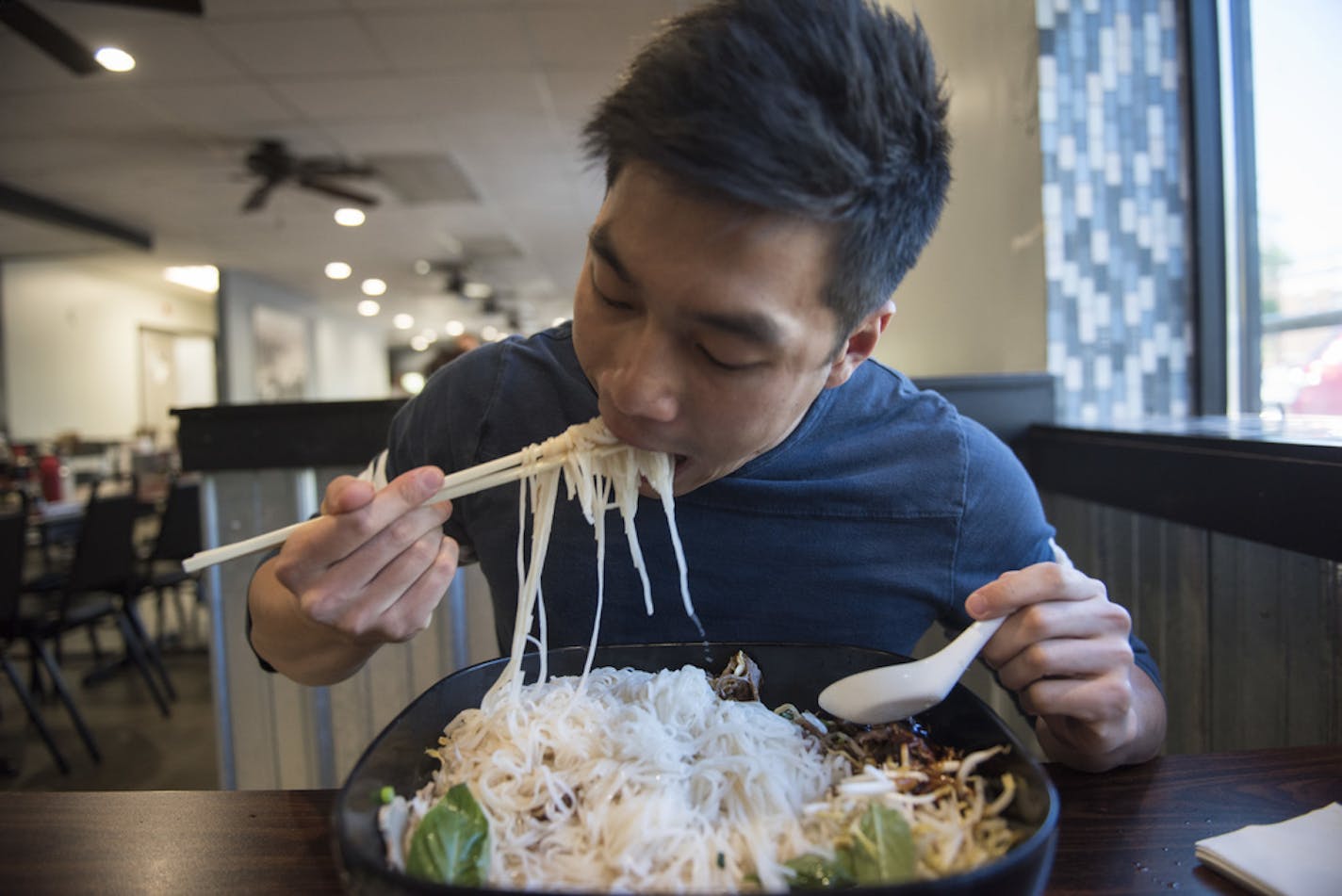 ] MARK VANCLEAVE &#x2022; mark.vancleave@startribune.com * Kai Chan, a local food and travel Instagrammer, attempts to down the the 10-lb. pho challenge at iPho by Saigon, in St. Paul on May 31, 2017.