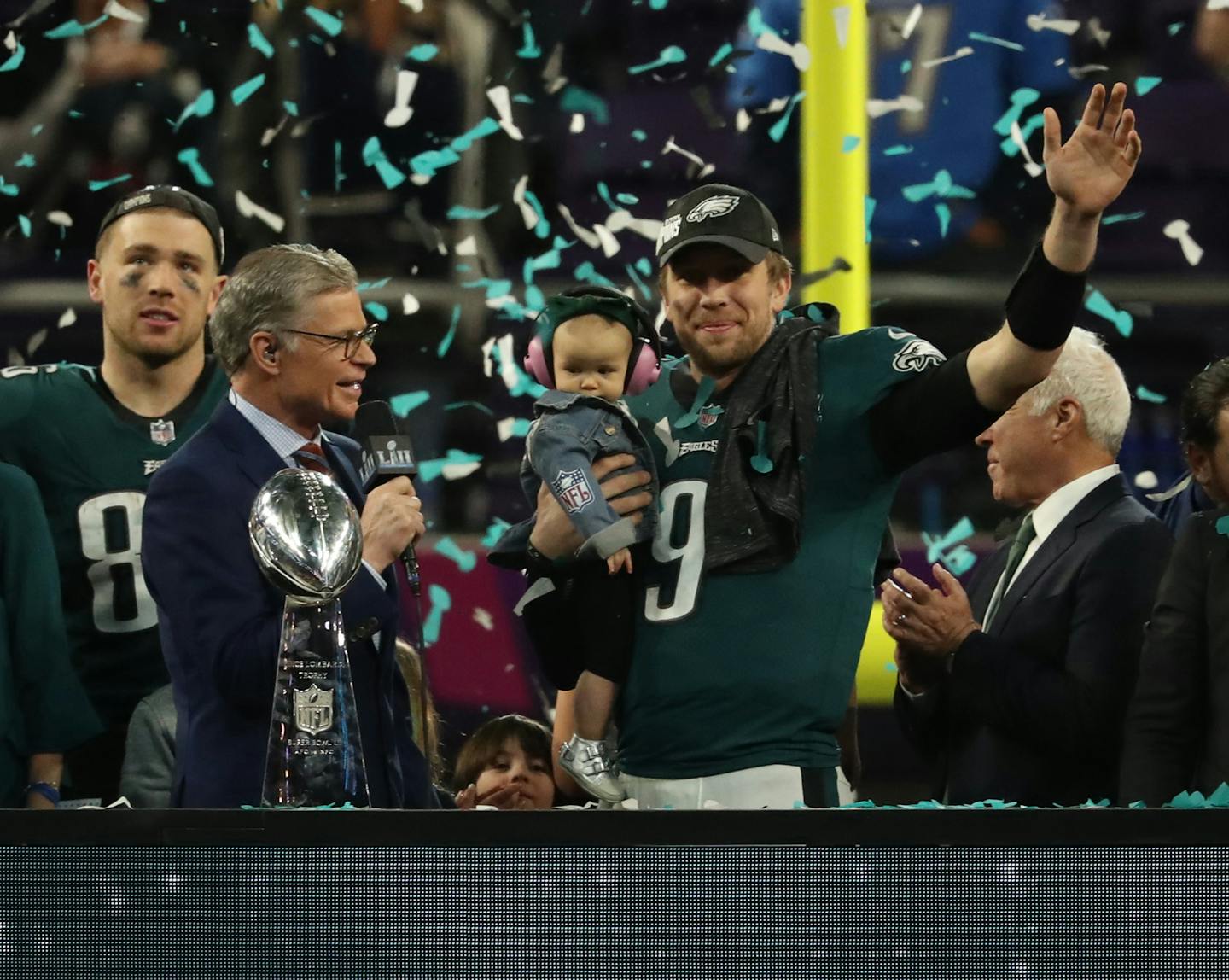 Eagles quarterback Nick Foles held his son and waved during the victory celebration after Super Bowl LII at U.S. Bank Stadium on Sunday.