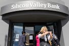 A woman who was part of a line entering the Silicon Valley Bank’s headquarters paused for a selfie in Santa Clara, Calif., on Monday, March 13, 2023
