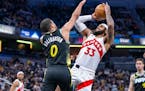 Raptors guard Gary Trent Jr. (33) made a shot attempt while being defended by Pacers guard Tyrese Haliburton on Monday in Indianapolis.