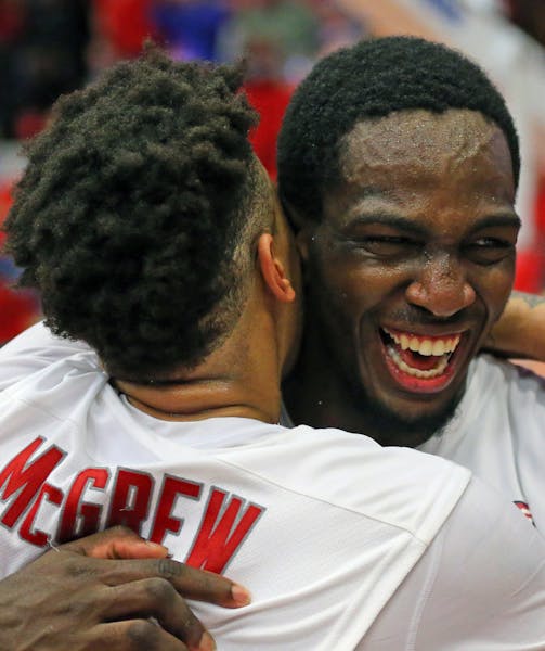 Stony Brook's Rayshaun McGrew, left, and Jameel Warney celebrate following their 80-74 win over Vermont in an NCAA college basketball game in the cham
