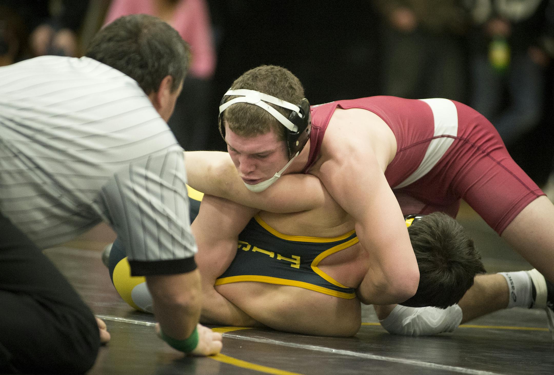 New Prague senior James Berg, top, rolls Hutchinson freshman Jeffery Thorson to his back before pinning him during Friday night's meet at Hutchinson High School. ] (Aaron Lavinsky | StarTribune) New Prague wrestling takes on Hutchinson at Hutchinson High School on Friday, Jan. 9, 2015.